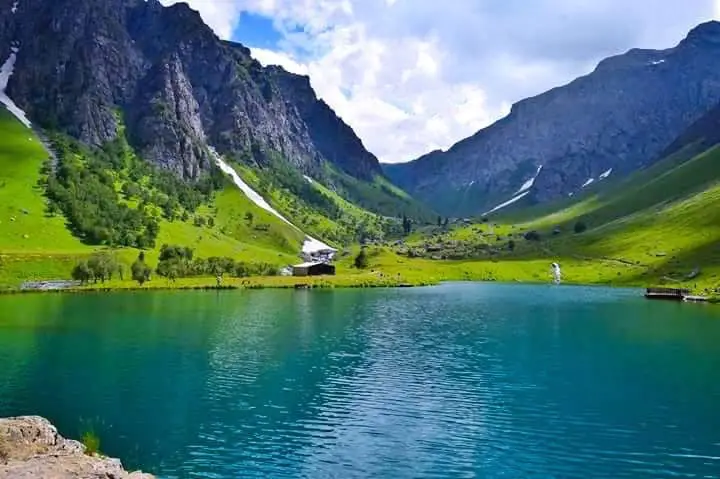 picturesque-lake-green-hills-mountains-snowy-peaks.jpg